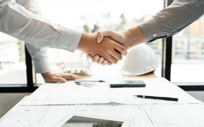 Architect en ingenieur bouwvakkers schudden de hand tijdens het werken voor teamwork en samenwerkingsconcept na het afronden van een overeenkomst op kantoor.